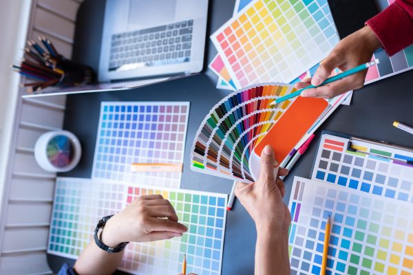 Group of artists brainstorming planning partnership strategy to coworkers in creative office.